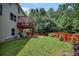 Spacious backyard with mature trees and a red fence for privacy at 204 Starwood Ct, Acworth, GA 30102