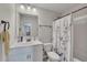 Well-lit bathroom featuring a vanity, toilet, and bathtub with a patterned shower curtain at 204 Starwood Ct, Acworth, GA 30102
