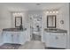 Bright bathroom featuring double vanities, granite counters, and a connecting doorway to the bedroom at 204 Starwood Ct, Acworth, GA 30102