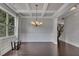 Elegant dining room featuring coffered ceilings, wainscoting, hardwood floors, and abundant natural light at 204 Starwood Ct, Acworth, GA 30102
