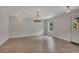 Open dining room with wood-look floors, modern lighting, and a window with outdoor views at 204 Starwood Ct, Acworth, GA 30102