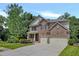 Attractive two-story home with stone and brick accents, lush landscaping, and a spacious two-car garage at 204 Starwood Ct, Acworth, GA 30102