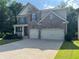Beautiful two-story home featuring a stone and siding exterior, two-car garage, and a well-manicured front yard at 204 Starwood Ct, Acworth, GA 30102
