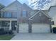 Attractive two-story house with stone and siding, featuring a two-car garage and a welcoming front porch area at 204 Starwood Ct, Acworth, GA 30102