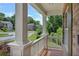 Inviting front porch with white railings and stately columns offering neighborhood views under a bright sky at 204 Starwood Ct, Acworth, GA 30102