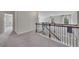 Upstairs hallway with carpet and wood banister leading to bedrooms at 204 Starwood Ct, Acworth, GA 30102