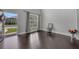 Bright living room featuring sleek dark hardwood floors and a glimpse of the outdoors through a large front door at 204 Starwood Ct, Acworth, GA 30102