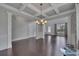 Bright living room with coffered ceiling, chandelier, and hardwood floors at 204 Starwood Ct, Acworth, GA 30102
