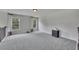 Open loft area with neutral carpeting, two windows, and a small dresser at 204 Starwood Ct, Acworth, GA 30102