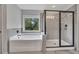 Main bathroom with soaking tub, large shower with glass doors and tiled walls at 204 Starwood Ct, Acworth, GA 30102