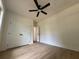 A bright bedroom is enhanced with a ceiling fan, hardwood floors, and double-door closet at 325 Garrison Se Dr, Marietta, GA 30060