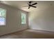 Well-lit bedroom with hardwood floors, neutral walls, and two large windows at 325 Garrison Se Dr, Marietta, GA 30060