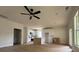 Bright, open-concept living space flowing into a modern kitchen, featuring hardwood floors and a ceiling fan at 325 Garrison Se Dr, Marietta, GA 30060