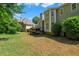 A backyard with grass extending from the back of a multi-story home with a deck and a view of trees at 4381 Laurian Nw Dr, Kennesaw, GA 30144