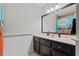 This bathroom offers a vanity with a dark wood cabinet and framed mirror at 4381 Laurian Nw Dr, Kennesaw, GA 30144