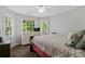 Bedroom with a patterned bedspread, dresser, and many windows at 4381 Laurian Nw Dr, Kennesaw, GA 30144
