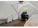 Bedroom features sloped ceilings, a ceiling fan, and neutral paint at 4381 Laurian Nw Dr, Kennesaw, GA 30144