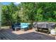 A deck featuring black wicker patio furniture with blue cushions and a barbecue grill at 4381 Laurian Nw Dr, Kennesaw, GA 30144