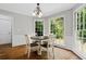 Charming breakfast nook with natural light from large windows overlooking the backyard and a round table with four chairs at 4381 Laurian Nw Dr, Kennesaw, GA 30144