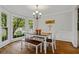 Bright dining room with large windows, hardwood floors, and a classic chandelier at 4381 Laurian Nw Dr, Kennesaw, GA 30144