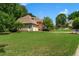 Spacious property featuring a lush green lawn and mature trees surrounding a traditional home at 4381 Laurian Nw Dr, Kennesaw, GA 30144