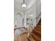 Elegant foyer with hardwood floors and staircase, showcasing a welcoming front door and chandelier at 4381 Laurian Nw Dr, Kennesaw, GA 30144