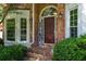Welcoming front door with decorative sidelights and brick steps, framed by lush greenery at 4381 Laurian Nw Dr, Kennesaw, GA 30144