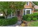 Inviting front entrance with brick facade, manicured shrubs, and a 'welcome' sign at 4381 Laurian Nw Dr, Kennesaw, GA 30144