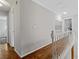 Hallway featuring hardwood flooring, white trim, and access to multiple rooms at 4381 Laurian Nw Dr, Kennesaw, GA 30144