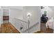 Hallway with hardwood floors, a staircase, and access to multiple rooms at 4381 Laurian Nw Dr, Kennesaw, GA 30144