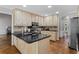 Bright kitchen with granite countertops, light wood cabinets, stainless steel appliances and hardwood floors at 4381 Laurian Nw Dr, Kennesaw, GA 30144