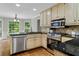 Bright kitchen featuring stainless steel appliances, granite countertops, a stylish backsplash and hardwood floors at 4381 Laurian Nw Dr, Kennesaw, GA 30144