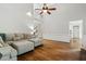 Living room showcasing hardwood floors, a comfortable sectional sofa, and an open layout with view to entry and staircase at 4381 Laurian Nw Dr, Kennesaw, GA 30144