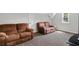 Spacious room featuring carpet and two reclining loveseats at 4381 Laurian Nw Dr, Kennesaw, GA 30144