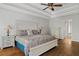 This main bedroom features a tray ceiling, ceiling fan, and hardwood floors at 4381 Laurian Nw Dr, Kennesaw, GA 30144