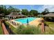 A community pool featuring a large swimming pool, lounge chairs, umbrellas and well-maintained landscaping at 4381 Laurian Nw Dr, Kennesaw, GA 30144