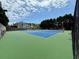 Tennis courts featuring blue and green surfaces surrounded by tall trees and blue skies at 4381 Laurian Nw Dr, Kennesaw, GA 30144
