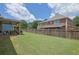 Spacious backyard with a well-maintained lawn and tall wooden privacy fence, ideal for recreation and relaxation at 675 Mallard Cv, Loganville, GA 30052