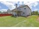 Expansive backyard with covered patio, lawn, and exterior view of the home at 675 Mallard Cv, Loganville, GA 30052