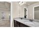 Bathroom vanity with double sinks and modern fixtures, adjacent to bedroom at 675 Mallard Cv, Loganville, GA 30052