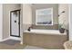 Bathroom featuring a soaking tub, walk-in shower, and window at 675 Mallard Cv, Loganville, GA 30052