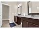 Bathroom featuring granite counters, double vanity, wood cabinets and tiled floors at 675 Mallard Cv, Loganville, GA 30052