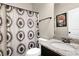 Bathroom featuring stylish shower curtain, granite vanity, and well-lit mirror at 675 Mallard Cv, Loganville, GA 30052
