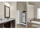 Bathroom featuring granite counters, wood cabinets, tiled floors, a tub and shower at 675 Mallard Cv, Loganville, GA 30052
