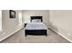 Well-lit bedroom with carpeted floors and modern neutral paint at 675 Mallard Cv, Loganville, GA 30052