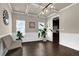 Elegant dining room with coffered ceiling, modern lighting, and wainscoting at 675 Mallard Cv, Loganville, GA 30052
