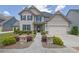 Charming two-story home with manicured lawn, stone accents, and inviting entryway at 675 Mallard Cv, Loganville, GA 30052