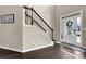 Inviting foyer featuring hardwood floors, elegant staircase, and white front door with glass panes at 675 Mallard Cv, Loganville, GA 30052