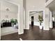 Spacious open-concept foyer with dark hardwood floors leading to a beautifully decorated living area at 675 Mallard Cv, Loganville, GA 30052