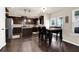 Open kitchen with dark wood cabinets, stainless steel appliances, and adjacent breakfast nook at 675 Mallard Cv, Loganville, GA 30052